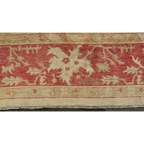 98A - A BEIGE GROUND ZIEGLER RUG WITH CENTRAL MEDALLION