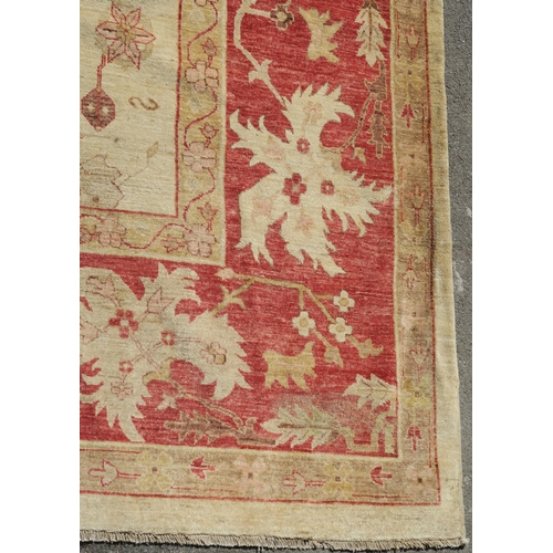 98A - A BEIGE GROUND ZIEGLER RUG WITH CENTRAL MEDALLION