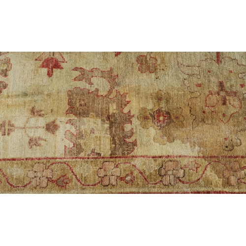 98A - A BEIGE GROUND ZIEGLER RUG WITH CENTRAL MEDALLION