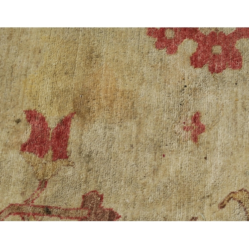 98A - A BEIGE GROUND ZIEGLER RUG WITH CENTRAL MEDALLION