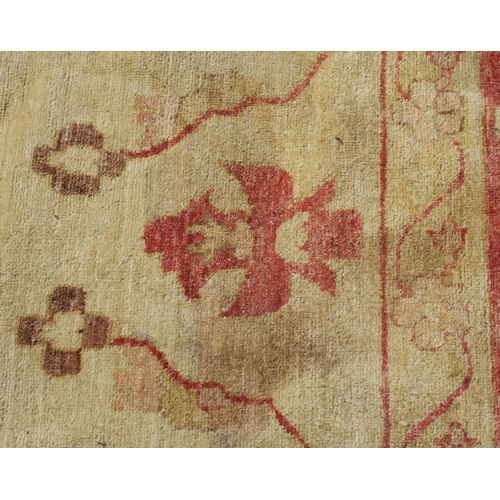 98A - A BEIGE GROUND ZIEGLER RUG WITH CENTRAL MEDALLION