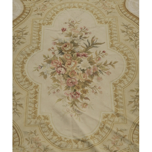 99 - A CREAM GROUND AUBUSSON STYLE RUG WITH CENTRAL MEDALLION