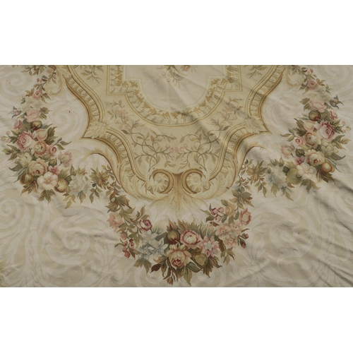 99 - A CREAM GROUND AUBUSSON STYLE RUG WITH CENTRAL MEDALLION