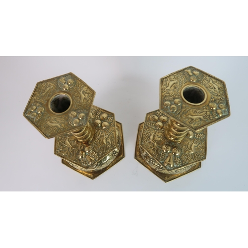 323 - A PAIR OF BRASS ARTS AND CRAFTS CANDLE HOLDERS