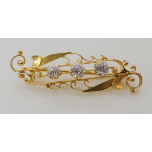 502 - A 15CT GOLD THREE DIAMOND BROOCH