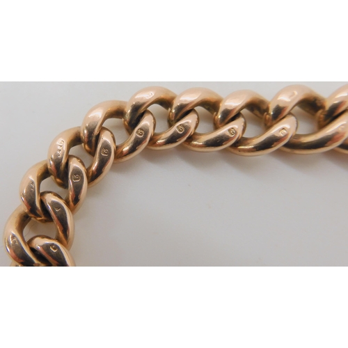 506 - A 9CT GOLD CURB LINK BRACELET WITH A HEART CLASP