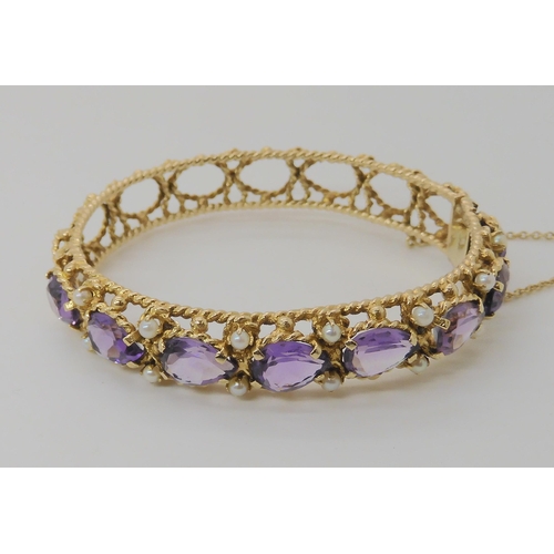 521 - A 14K GOLD AMETHYST AND PEARL BANGLE