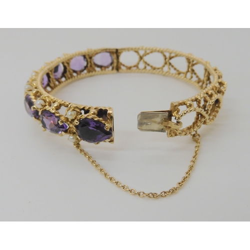 521 - A 14K GOLD AMETHYST AND PEARL BANGLE