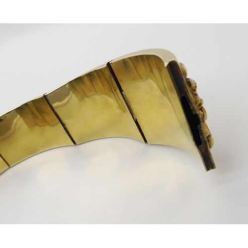 522 - A GILDED WHITE METAL REPOUSSE INDIAN BANGLE