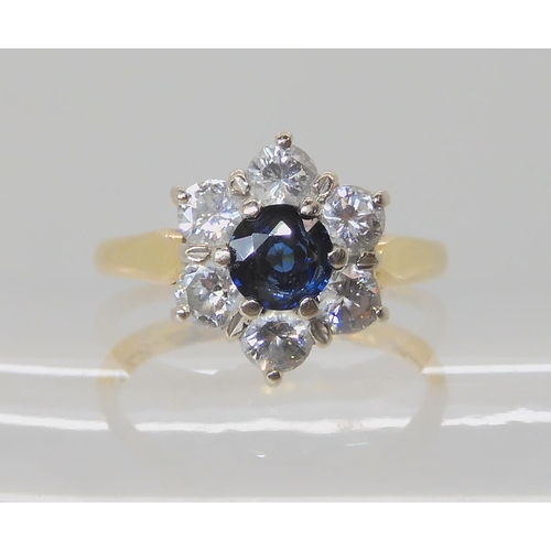 534 - AN 18CT SAPPHIRE AND DIAMOND FLOWER RING