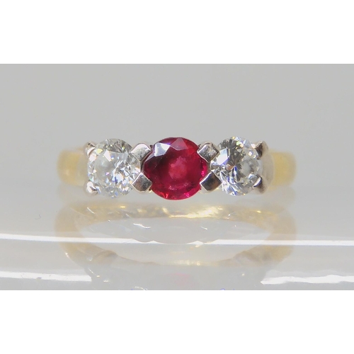 535 - AN 18CT GOLD RUBY AND DIAMOND THREE STONE RING