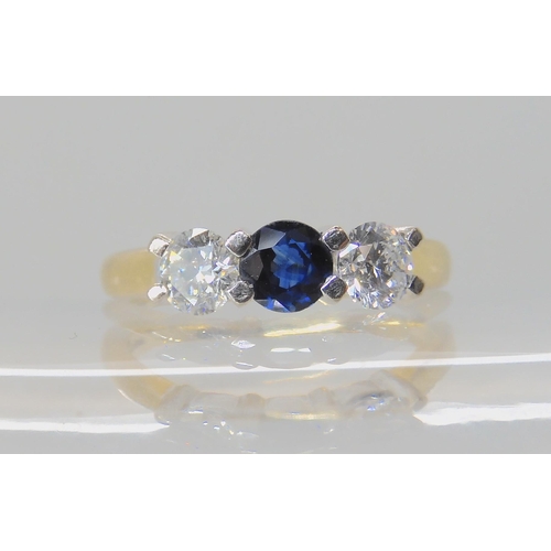 536 - AN 18CT GOLD SAPPHIRE AND DIAMOND THREE STONE RING