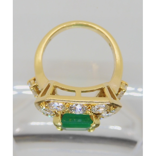 557 - AN 18CT GOLD EMERALD AND DIAMOND DRESS RING