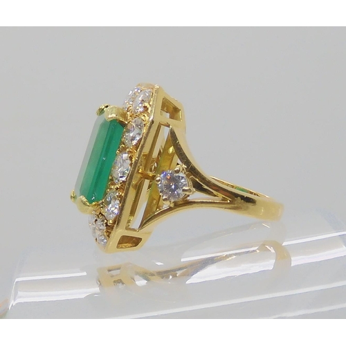 557 - AN 18CT GOLD EMERALD AND DIAMOND DRESS RING