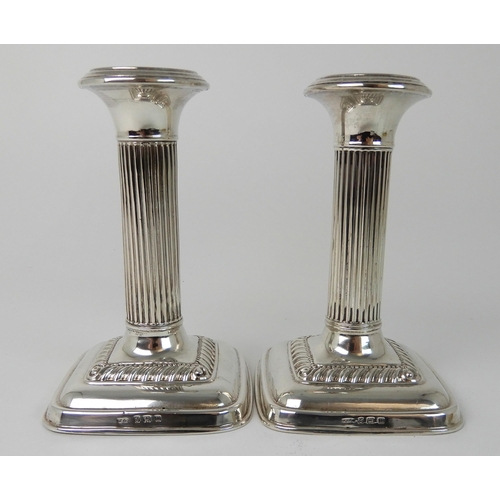 698 - A PAIR OF SILVER CANDLESTICKS