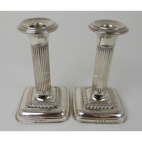 698 - A PAIR OF SILVER CANDLESTICKS