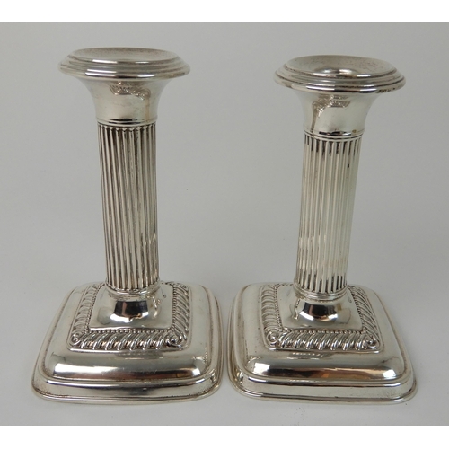 698 - A PAIR OF SILVER CANDLESTICKS