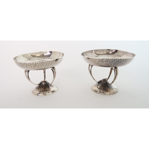 750 - A PAIR OF ARTS AND CRAFTS HAMMERED SILVER BON BON DISHES