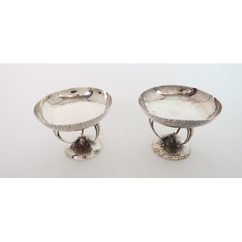 750 - A PAIR OF ARTS AND CRAFTS HAMMERED SILVER BON BON DISHES