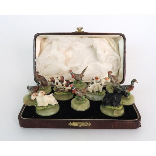 299 - A BOXED SET OF FOUR COLD PAINTED SPELTER DOG NAME HOLDERS