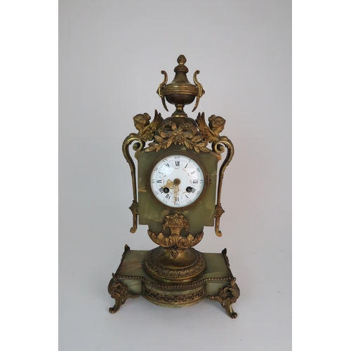 337 - A FRENCH ONYX AND ORMOLU MOUNTED MANTLE CLOCK