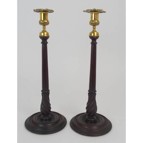 431 - A PAIR OF MAHOGANY AND BRASS MOUNTED CANDLE STICKS