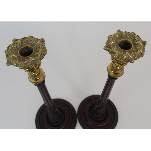 431 - A PAIR OF MAHOGANY AND BRASS MOUNTED CANDLE STICKS