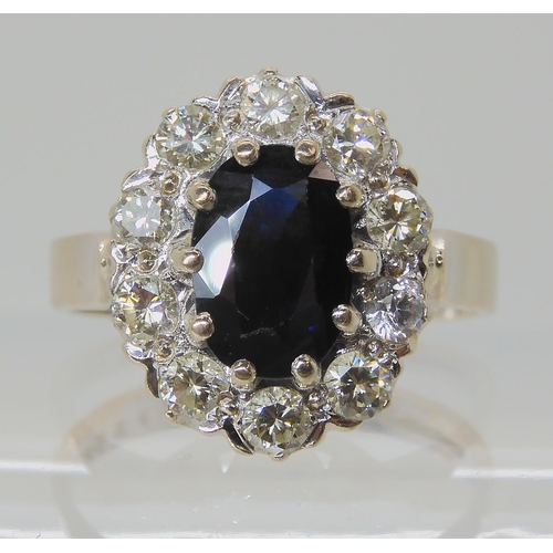 527 - AN 18CT WHITE GOLD SAPPHIRE AND DIAMOND CLUSTER RING