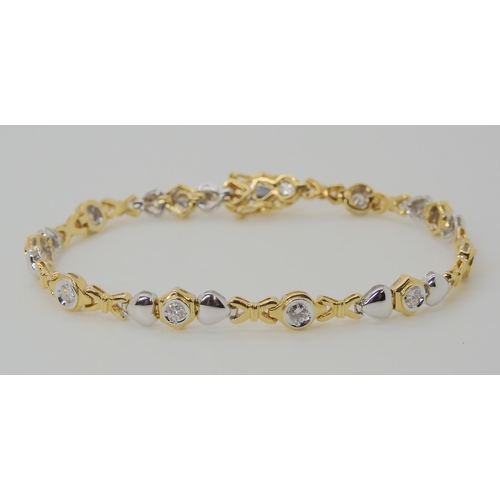 536 - AN 18CT YELLOW AND WHITE GOLD HEART PATTERN DIAMOND BRACELET