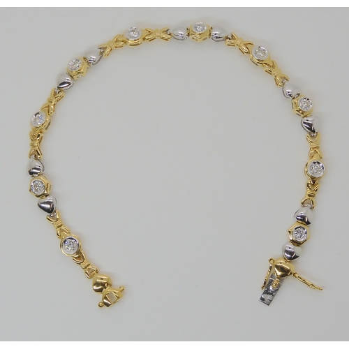 536 - AN 18CT YELLOW AND WHITE GOLD HEART PATTERN DIAMOND BRACELET