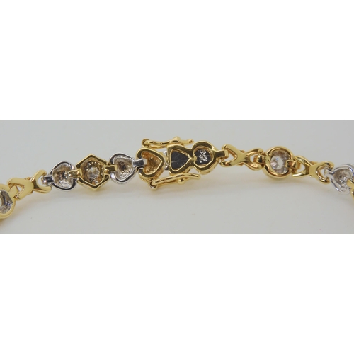 536 - AN 18CT YELLOW AND WHITE GOLD HEART PATTERN DIAMOND BRACELET