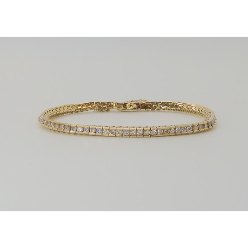 548 - A 14K YELLOW GOLD DIAMOND TENNIS BRACELET