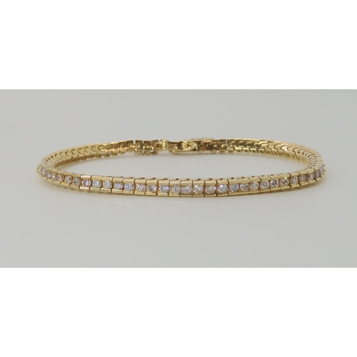 548 - A 14K YELLOW GOLD DIAMOND TENNIS BRACELET