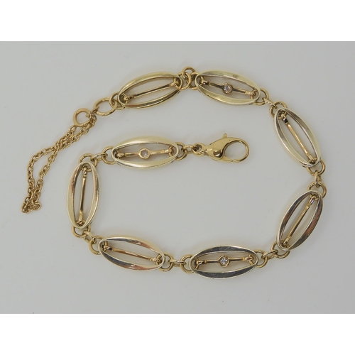 564 - A 9CT GOLD DIAMOND SET FANCY LINK BRACELET