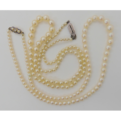 566 - TWO STRINGS OF PEARLS WITH DECORATIVE CLASPS