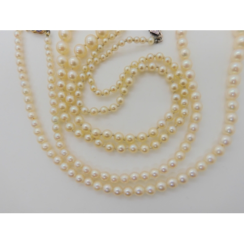 566 - TWO STRINGS OF PEARLS WITH DECORATIVE CLASPS