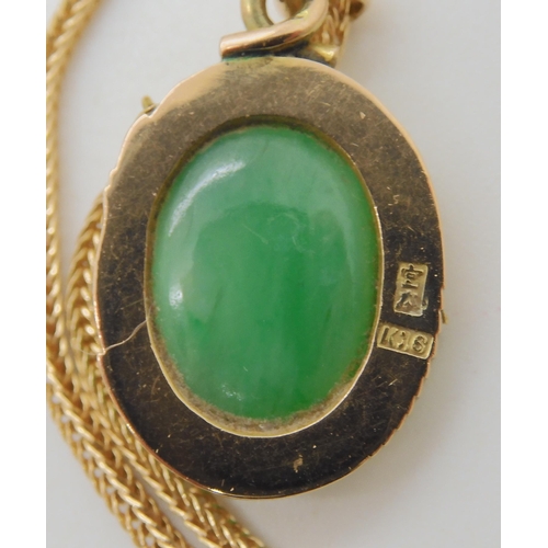 570 - A CHINESE GREEN HARDSTONE AND DRAGON PENDANT