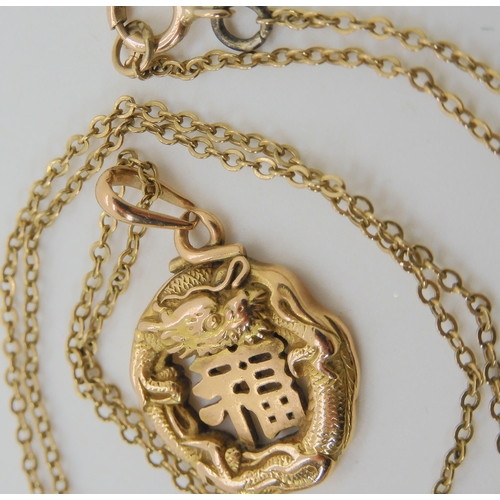 574 - A CHINESE 16K GOLD DRAGON PENDANT