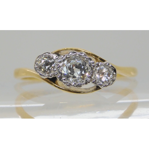 577 - AN 18CT AND PLATINUM THREE STONE RING