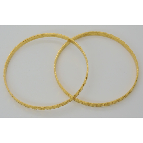 587 - TWO INDIAN GOLD BANGLES