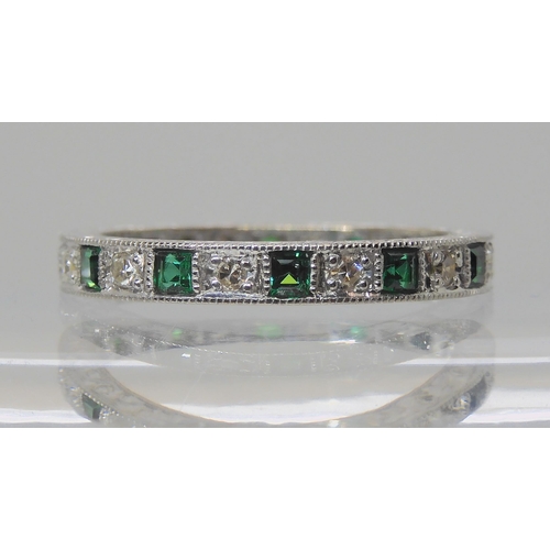 605 - AN 18CT WHITE GOLD GREEN GEM AND DIAMOND ETERNITY RING