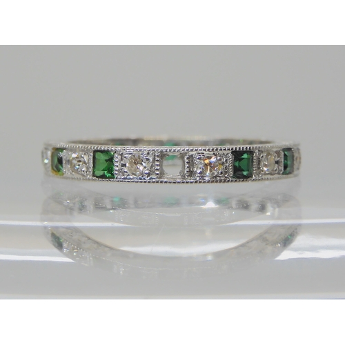 605 - AN 18CT WHITE GOLD GREEN GEM AND DIAMOND ETERNITY RING