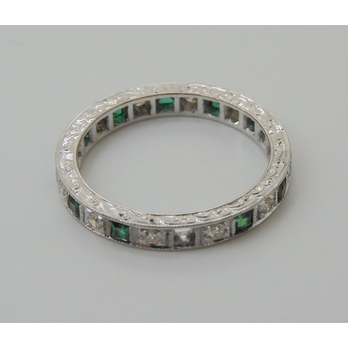 605 - AN 18CT WHITE GOLD GREEN GEM AND DIAMOND ETERNITY RING