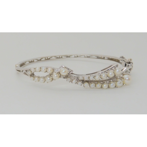 635 - A 14K WHITE GOLD PEARL BANGLE