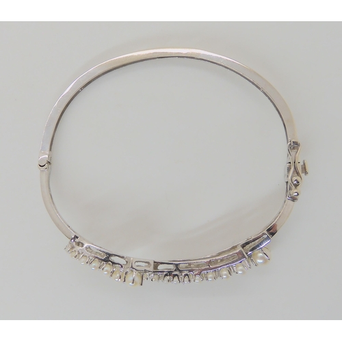 635 - A 14K WHITE GOLD PEARL BANGLE