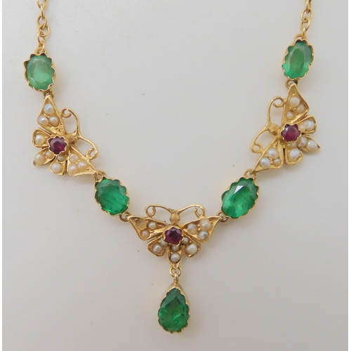 652 - A 15CT GOLD RUBY EMERALD AND PEARL SET MOTH NECKLACE