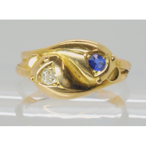 672 - AN 18CT GOLD SAPPHIRE AND DIAMOND SNAKE RING