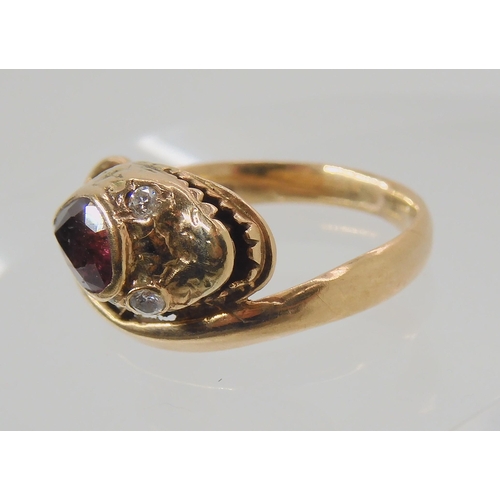 675 - A 9CT ROSE GOLD GARNET AND DIAMOND SNAKE RING