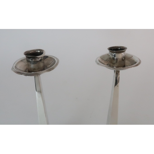 719 - A PAIR OF ARTS AND CRAFTS SILVER CANDLESTICKS