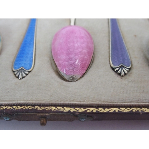 736 - A CASED SET OF SIX SILVER GILT AND ENAMEL COFFEE SPOONS